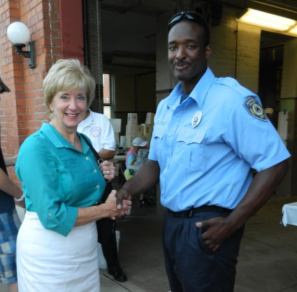 Republican candidate from Connecticut fro U.S. senate, Linda McMahon shakes hands with firefighter Ernest Jones during the Peach Festival August 24 in Manchester, CT.