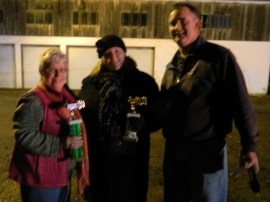 Sharran Selig Bennett accepts the first place trophy, on behalf of Four Seasons Landscaping, from Ashley of First Town Downtown and Windsor Firefighter Tom Dillon.