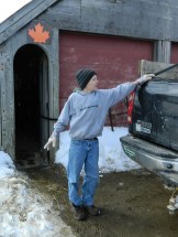 Anthony Comte shows piping from a tank of sap outside the sugarhouse.