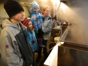 Andrew, Abby, Charlotte and their mother Heather watch the boiling off process.