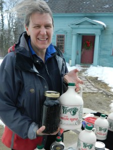 Susan Comte displays maple syrup produced at the Comte Farm sugarhouse in Nottingham, New Hampshire.