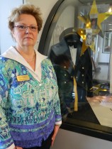 Diane DeLuzio, whose son was killed in Afghanistan, stands by his dress uniform which is part of the memorial display.
