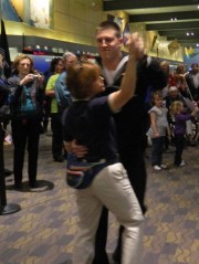 Seaman Cameron Slate of Knoxville, Illinois, dances with Bradley Airport Marketing Coordinator Stacey Doan.