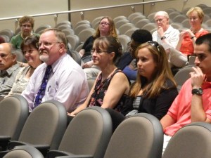 With his wife and a daughter at his side, Windsor, Connecticut Mayor Don Trinks listens to nominations at the July 18 Democratic caucus.