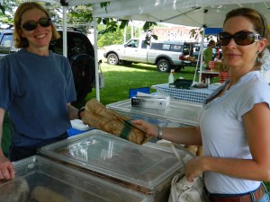 Wendy Maranda (right) buys a loaf of artisan bread from Doreen Near of Two Dog Baking Company.