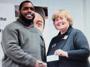 Foodshare courtesy photo - Chris Baker of the Washington Redskins  and Gloria McAdam.