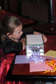 Great-0great granddaughter pretty Sofia helped Nana open her gifts.