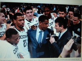 From UConn Today Kevin Ollie shown surrounded by his team last year.