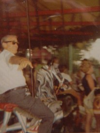 Dad/Big Johnny riding a carousel.