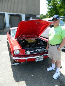 Fil Ferrauto, CT State Director of Mustang Car Club of New England, Inc. pictured with one of four Mustangs he owns. 