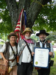 Members of the Swiss-American fife & drum corps, the Wild Bunch, display a proclamation  presented to them from the state of Connecticut.