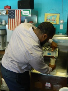 Chris mixes a milkshake.