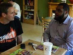 Dan Nolan and Chris Baker converse at Bart's where Baker came by to promote his foundation which aims to teach children football, literacy and leadership skills.