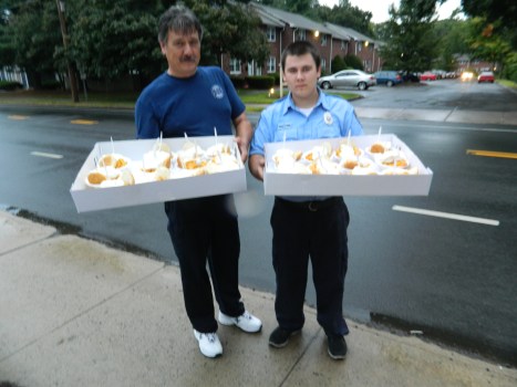 Special delivery! Father and son Stefan and Christopher Zajac, of the 8th Utilies District Fire Department in Manchester, Connecticut, prepare to make a peach shortcake run to local police officers and medics during the 65th Annual Peach Festival held August 22, 2014.