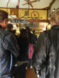 A view of the Vanilla Bean main counter as seen behind leather jackets in a long but quickly line.