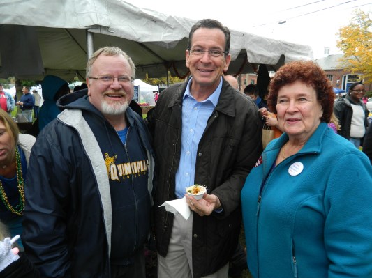 Inumbent Democrat Dannel Malloy is claiming victory in Connecticut's tight gubernatorial race. Malloy is shown here with fellow Democrats Mayor Donald Trinks and Registrar of Voters Anita Mips both of Windsor, CT at the town's  annual  Chili Challenge held in October. 