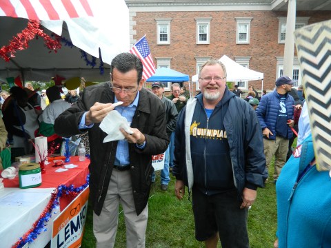 So good ... Gov. Dannel Malloy gives his approval to the chili made by fellow Democrat Mayor Don Trinks as Trinks looks on during the 2014 annual Chili Challenge held October 11 in Windsor, Connecticut.
