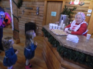 Juliana and Isla Mayer of Manchester enjoy apples from Mrs. Claus.