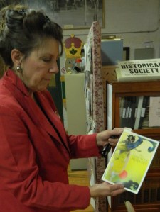 Eileen Sweeney of the Manchester Historical Society shows a worker recruitment brochure the Cheney Brothers had produced in five languages.