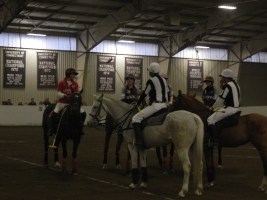 Teams meet center arena with umpires before the start of the match.