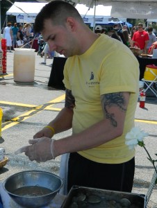 Shucking clams on the pot for the Harbour House booth at the Taste of Mystic.