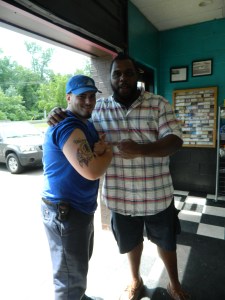 Jonathan DeMaio shows  his Washington Redskins tattoo to Chris Baker.