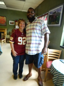 Carol Engelmann, owner of The Beanery and a loyal Redskins fan shown with #92 himself defensive lineman Chris Baker.