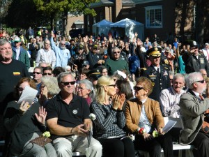 Vietnam veterans in the audience stand.