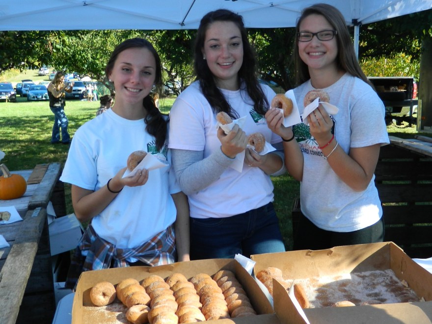 Handing out donuts & cider.