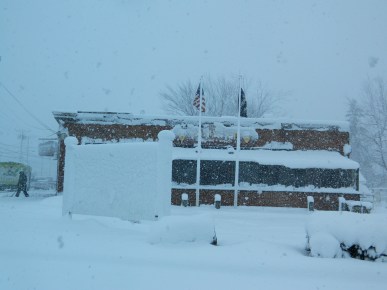 Signs outside the Main Pub whited out by the snowfall.