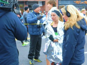 Women's winner Emily Sisson awaits the start of her post-race interview.