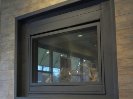 A fireplace separates two dining areas.